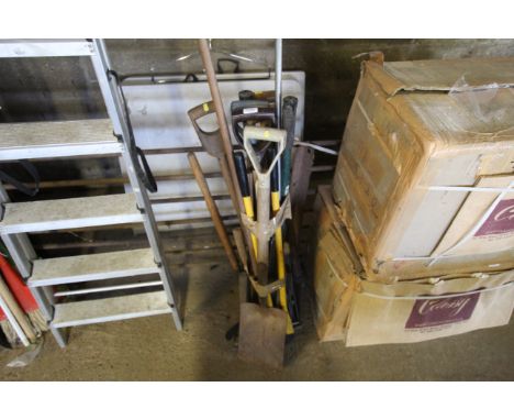 A quantity of various garden tools including fork, rake, pick axe, garden shears etc
