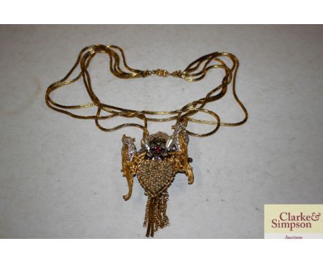 A faux pearl and gilt metal parrot decorated pendant
