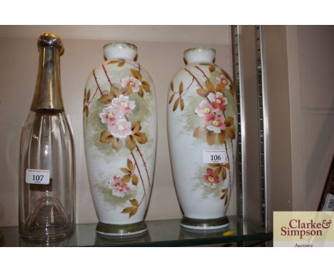 A pair of Victorian opaque baluster glass vases with enamel floral decoration 
