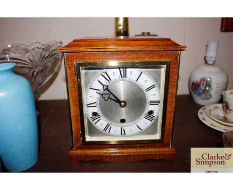 An early 20th oak triple hole bracket clock by Elliott striking with Westminster / Whittington chimes with silvered dial