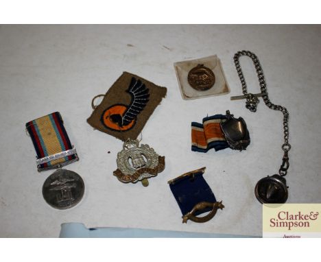 A silver medallion on chain, a Gulf medal 1990-91 24891161 DVR D R Tuckwood RCT, various cloth badges, cup badge etc.