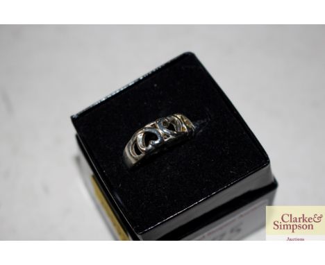A boxed white metal and heart decorated ring 