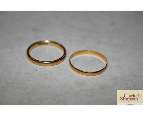 A yellow metal ring 1gm; and an 18ct gold ring 2.5gms