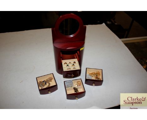 A small wooden trinket cabinet and contents of various costume rings and jewellery 