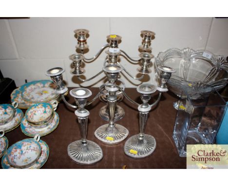 A pair of plate on copper three light candelabra; a single three light candelabra; and pair of matching candlesticks 