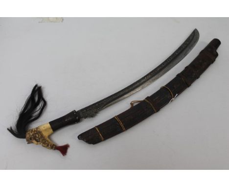 Fine 19th century Borneo Dayak Headhunters sword with carved bone hilt with skull decoration and hair plumes, slightly curved