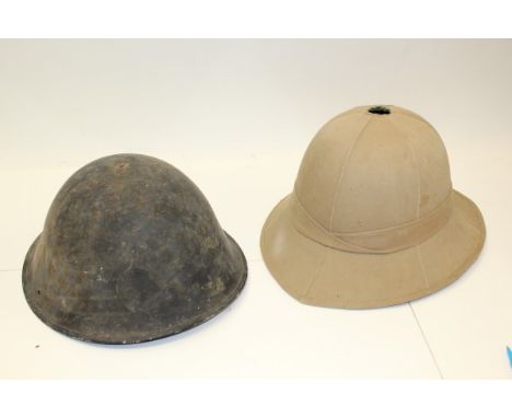 Second World War Italian steel  helmet with elasticated chin strap, together with a pith helmet with leather head ring (2) 