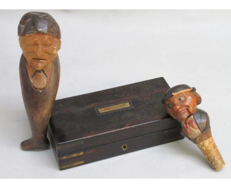 BLACK FORSET CARVED WOODEN FIGURAL NUTCRACKER (L: 19 cm),  A WOODEN JOLLY JACK TAR BOTTLE STOPPER CORK AUTOMATON (L: 11.5 cm)