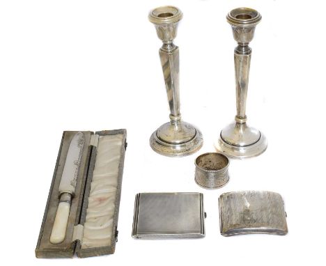 A selection of silver items, A selection of silver items, to include a pair of candlesticks, cigarette cases, napkin ring, et