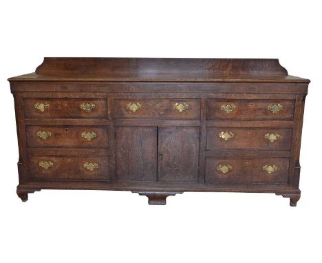 George III Oak Dresser Base George III oak dresser base, shaped backboard on a rectangular two plank top with cross-banding, 