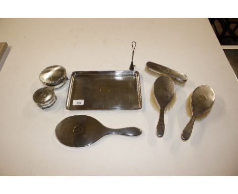 A silver engine turned decorated dressing table tray, matching brush and mirror set, and two trinket boxes