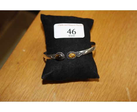 A white metal and tigers eye bangle 