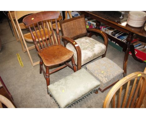 A 1930's low armchair with rattan back; two upholstered foot stools; and an elm seated stick back kitchen chair