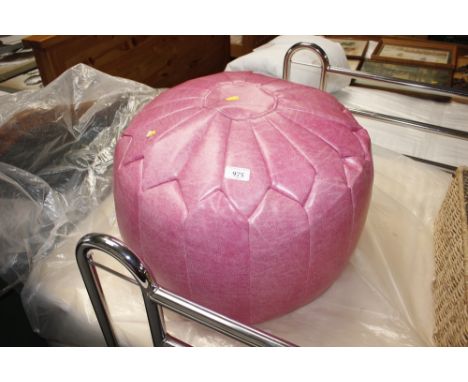 A pink faux leather pouffe