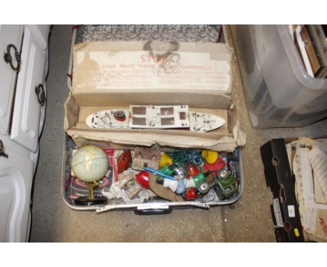 A suitcase of old toys including a Chad Valley globe etc.