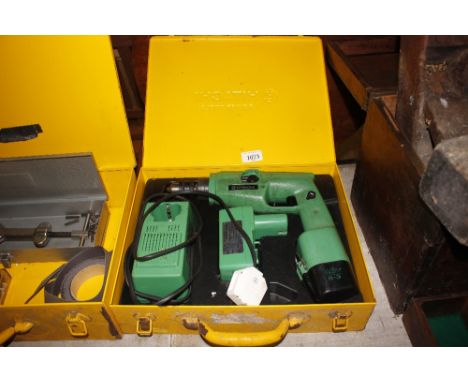 A Hitachi power drill in fitted metal case 