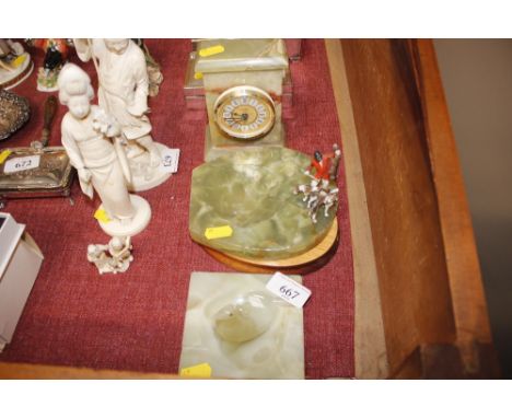 An onyx mantel clock; an onyx ash tray with fox hunting decoration; another; and an onyx bird 
