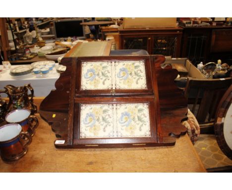 An Edwardian hanging corner cupboard with tile insert doors