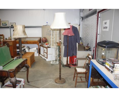 A turned wooden standard lamp and shade