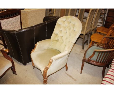 A Victorian button back upholstered armchair 