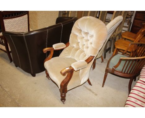 A Victorian button back upholstered armchair 