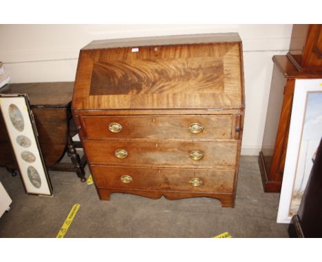A Georgian mahogany and cross banded bureau fitted three drawers below on bracket feet 