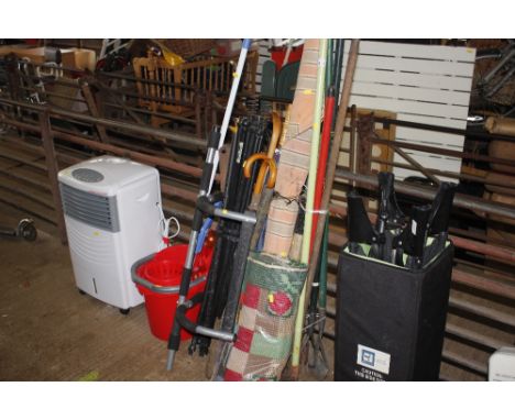 A quantity of various garden tools; drain rods; parasol etc. 