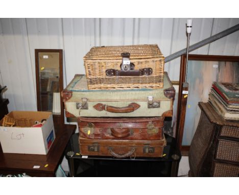 A wicker picnic hamper; and three vintage suitcases
