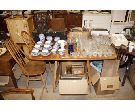 An Ercol drop leaf kitchen table; and a pair of stick back chairs 