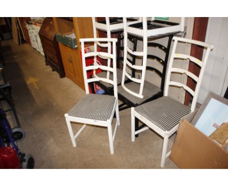 A set of six black and white painted ladder back dining chairs
