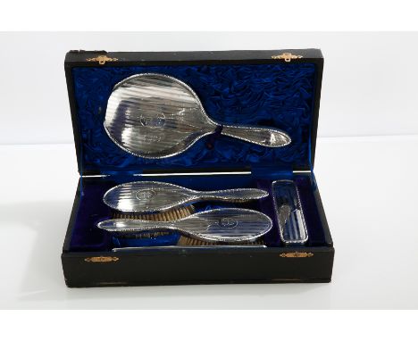 GEORGE V SILVER VANITY SET
maker Synyer & Beddoes, Birmingham 1915, comprising a hand mirror, two hair brushes, a clothes bru