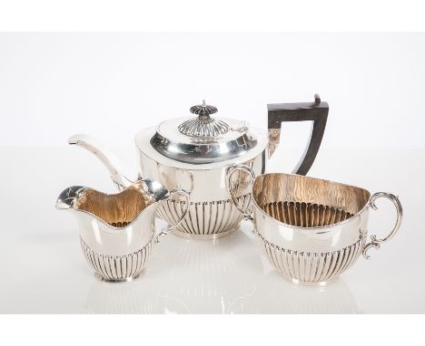 EDWARDIAN SILVER THREE-PIECE TEA SERVICE
maker Daniel George Collins, Birmingham 1904, partially gadrooned, approximately 907