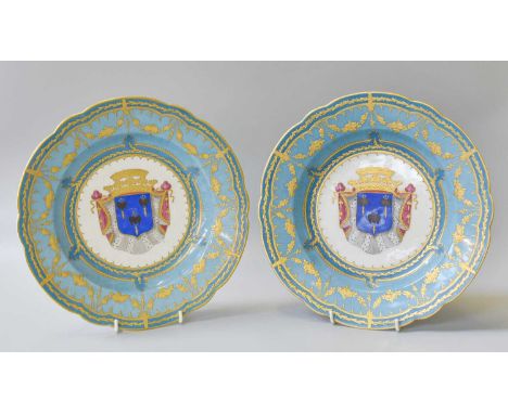 A Pair of Sèvres Style Porcelain Plates, 20th century, painted to the centres with coats of arms under wide blue ground borde
