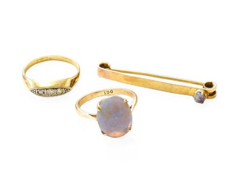A Diamond Five Stone Ring, the graduated eight-cut and old cut diamonds in white claw settings, to a yellow plain polished sh