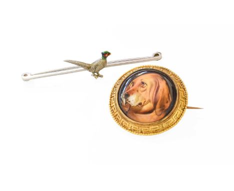 A Victorian Ceramic Brooch, the domed ceramic panel painted to depict a bloodhound, in a Greek key pattern and bead work bord