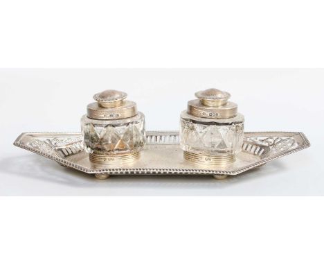 A George V Silver Inkstand, by William Hutton and Sons Ltd., London, 1899, shaped oblong, with pierced border below gadrooned