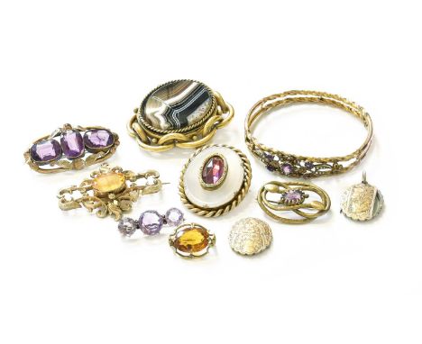 A Citrine Brooch, the oval cut citrine within a quatrefoil border, length 6.3cm; An Amethyst Three Stone Brooch, length 3.9cm