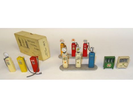 Britains Petrol Pumps etc. two FIRST VERSION, three SECOND VERSION, two three pump stands, and an oil cabinet, with empty ori