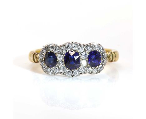 An Edwardian sapphire and diamond triple cluster ring,with three graduated oval Swiss cut sapphires, surrounded by old eight 