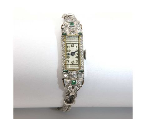 An Art Deco emerald and diamond set mechanical cocktail watch, c.1925,with a rectangular case with a silvered dial, raised bl