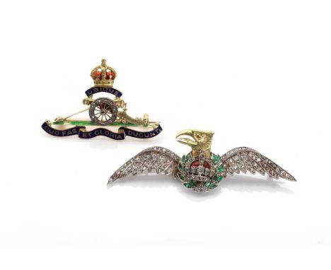 A diamond and emerald set military wings brooch, with a retro fitted eagle head centre, with a red enamel crown. Tested as ap