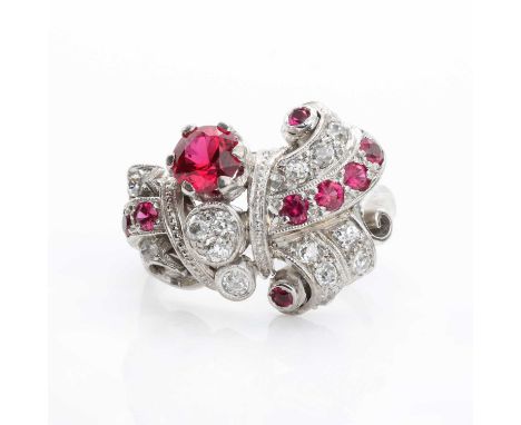 An abstract diamond and synthetic ruby ring,with a round cut synthetic ruby and eight smaller ones in a scrolling composition