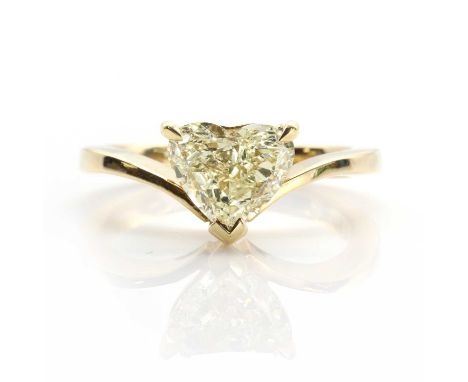 A heart-shaped fancy light yellow diamond ring, † the diamond three claw set in the angle of a plain tapered wishbone band, s