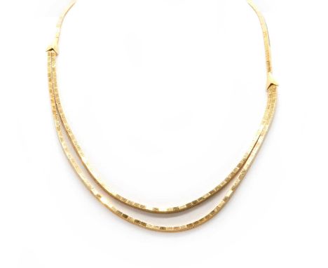 An Italian gold graduated necklace and bracelet, by UnoAerre, c.1960,with a two row block link necklace with chevron caps to 