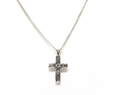 A white gold diamond set Latin cross,with rows of channel set brilliant cut diamonds, to a split bale, suspended on an 18ct w