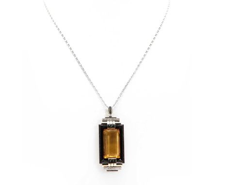 An American Art Deco, odeonesque, citrine, onyx and diamond brooch/pendant, c.1935,a rectangular step cut citrine, end set wi