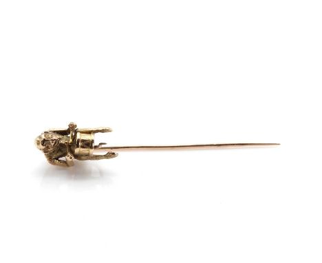 A novelty 'monkey playing a drum' stick pin,with textured fur and a decorated drum. Tested as approximately 15ct gold, 2.34g,