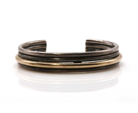 A four row two colour torque bangle, by Carl Antonsen,with three white and one yellow raised wire rows. Marked 925 CA, 60mm x