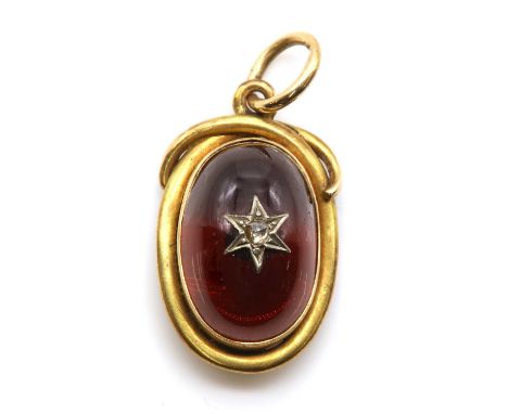 A Victorian cabochon garnet pendant, with an oval cabochon garnet with an applied rose cut diamond star. A graduated wire fra
