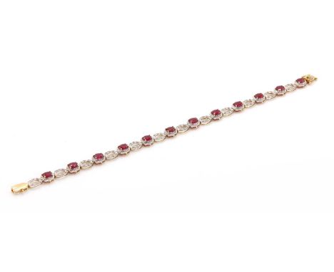 An 18ct gold ruby and diamond line bracelet,with a series of oval mixed cut rubies, claw set in yellow, to a scalloped white 